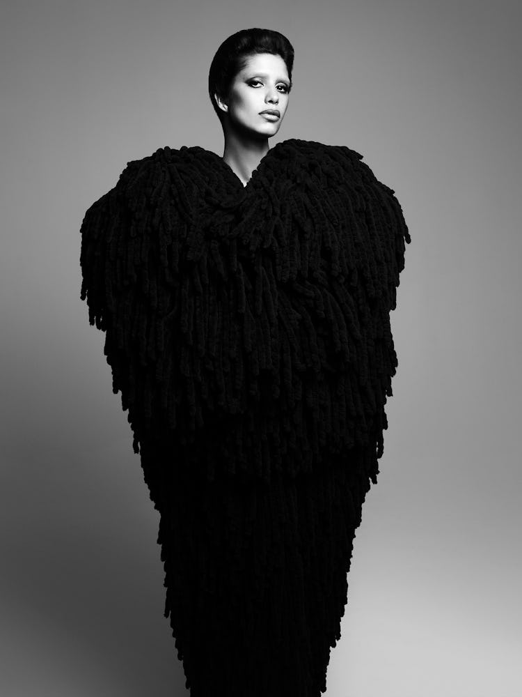 Model wears a black coat.