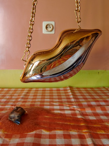 Chrome handbag shaped like a women's lips.