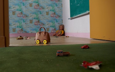 Brown leather bag in a playroom.