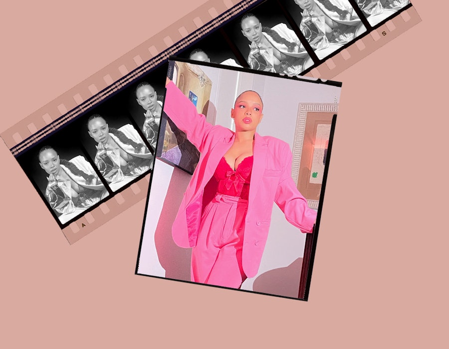 Sisi Stringer in a bright pink suit with a matching corset top and a slicked-back ponytail.