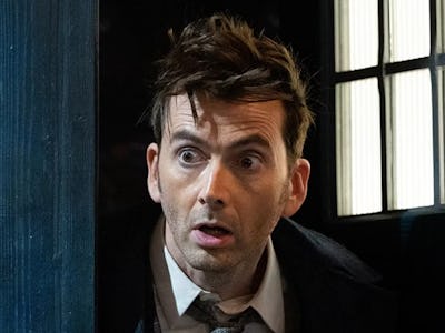 David Tennant as Doctor Who, peaking out of a door with a shocked facial expression