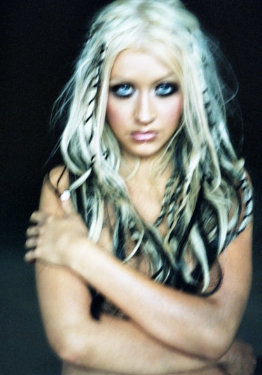 christina aguilera during the stripped album years with blonde and black hair and heavy kohl eyeline...