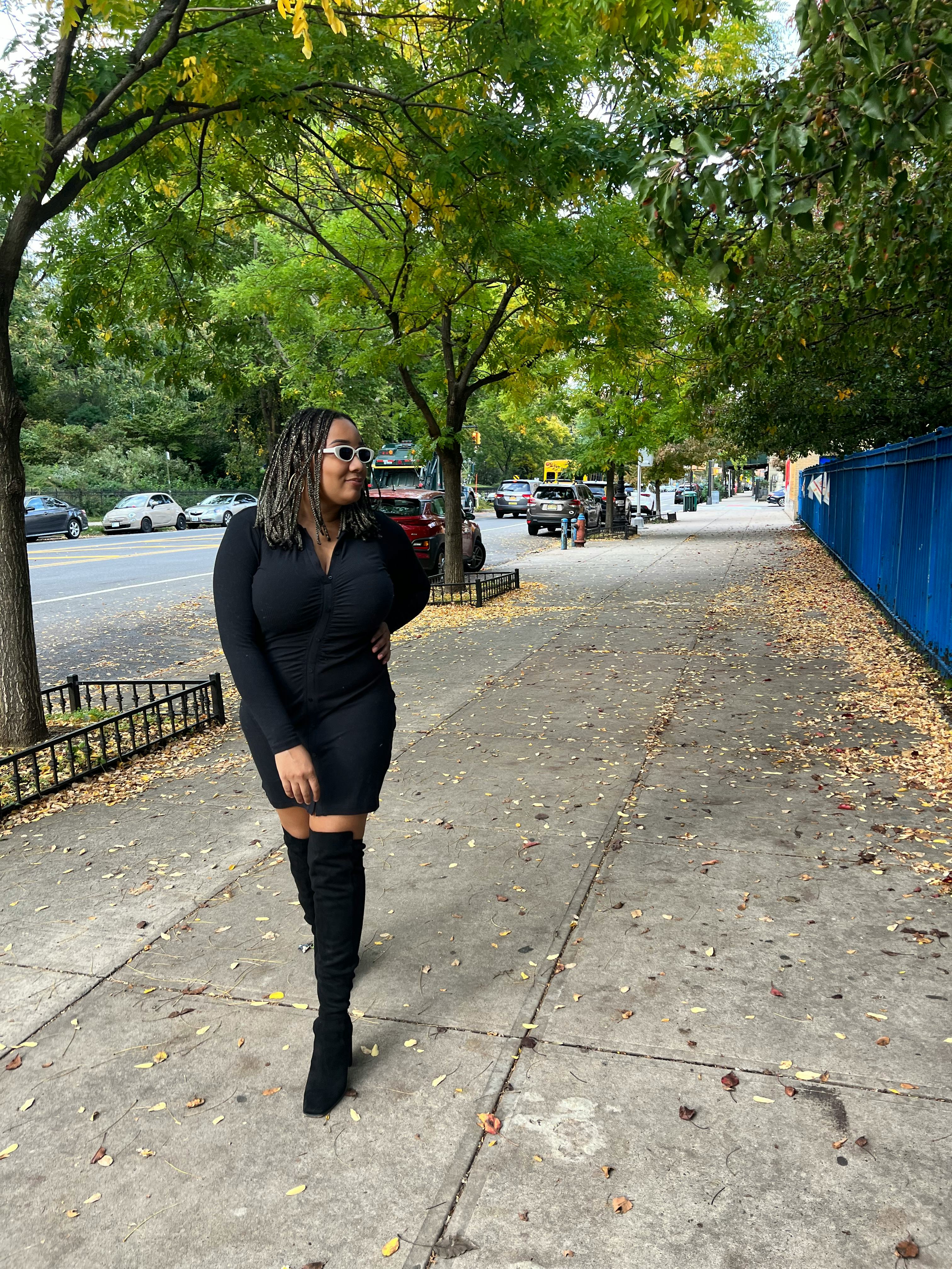 A mid-size woman posing in an Abercrombie black long-sleeve shirt dress