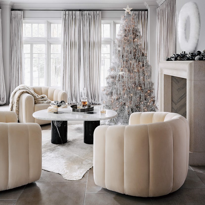 Sophisticated, minimal, and modern living room decorated for holidays by CB2