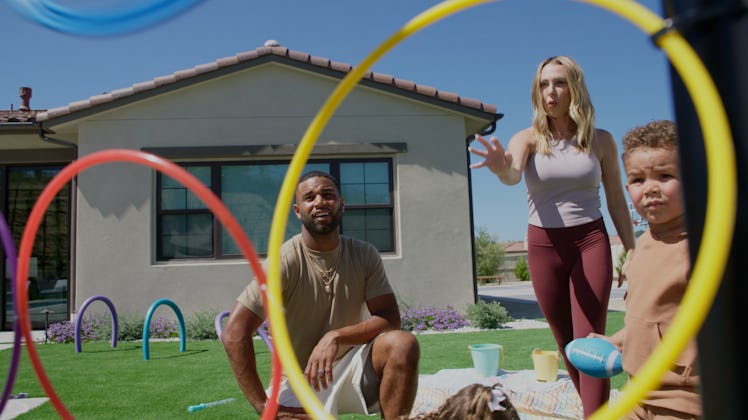 Elise and Golden Tate playing with their son and hula hoops on their family field day