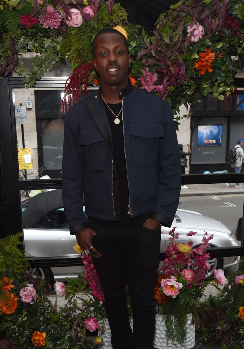 Jamal Edwards in a black jacket, black pants and a plain black shirt 