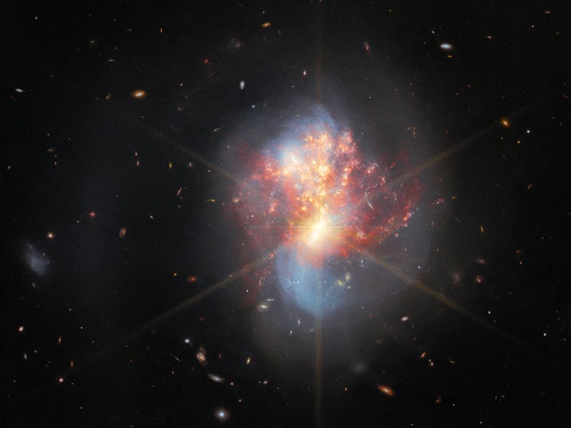 Spiral red, blue, and yellow galaxy on a black background