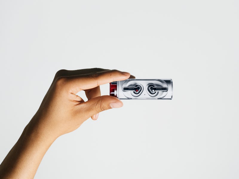 A hand holding the Nothing Ear Stick wireless earbuds