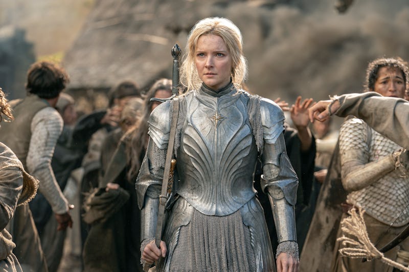 Morfydd Clark as Galadriel wearing steel armor while carrying a sword on her back