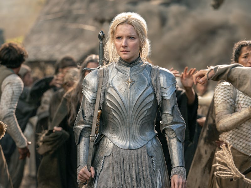 Morfydd Clark as Galadriel wearing steel armor while carrying a sword on her back