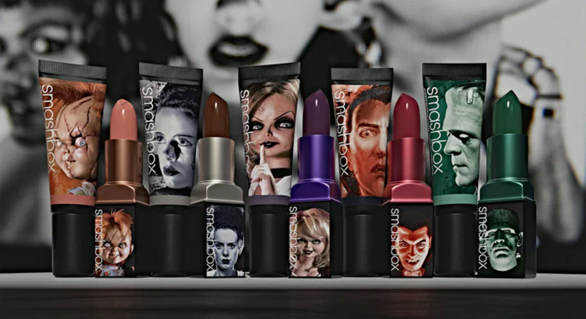 Cover of a catalogue with a model in black and white and four strong colored lipsticks in the focus
