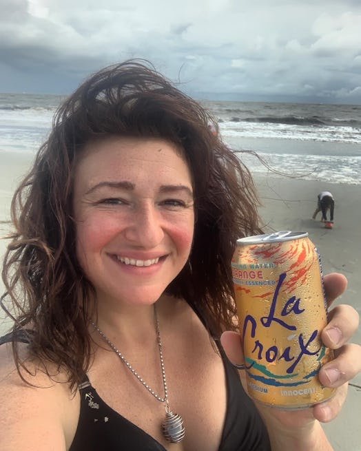 The author on the beach with a non-alcoholic drink a year after quitting.