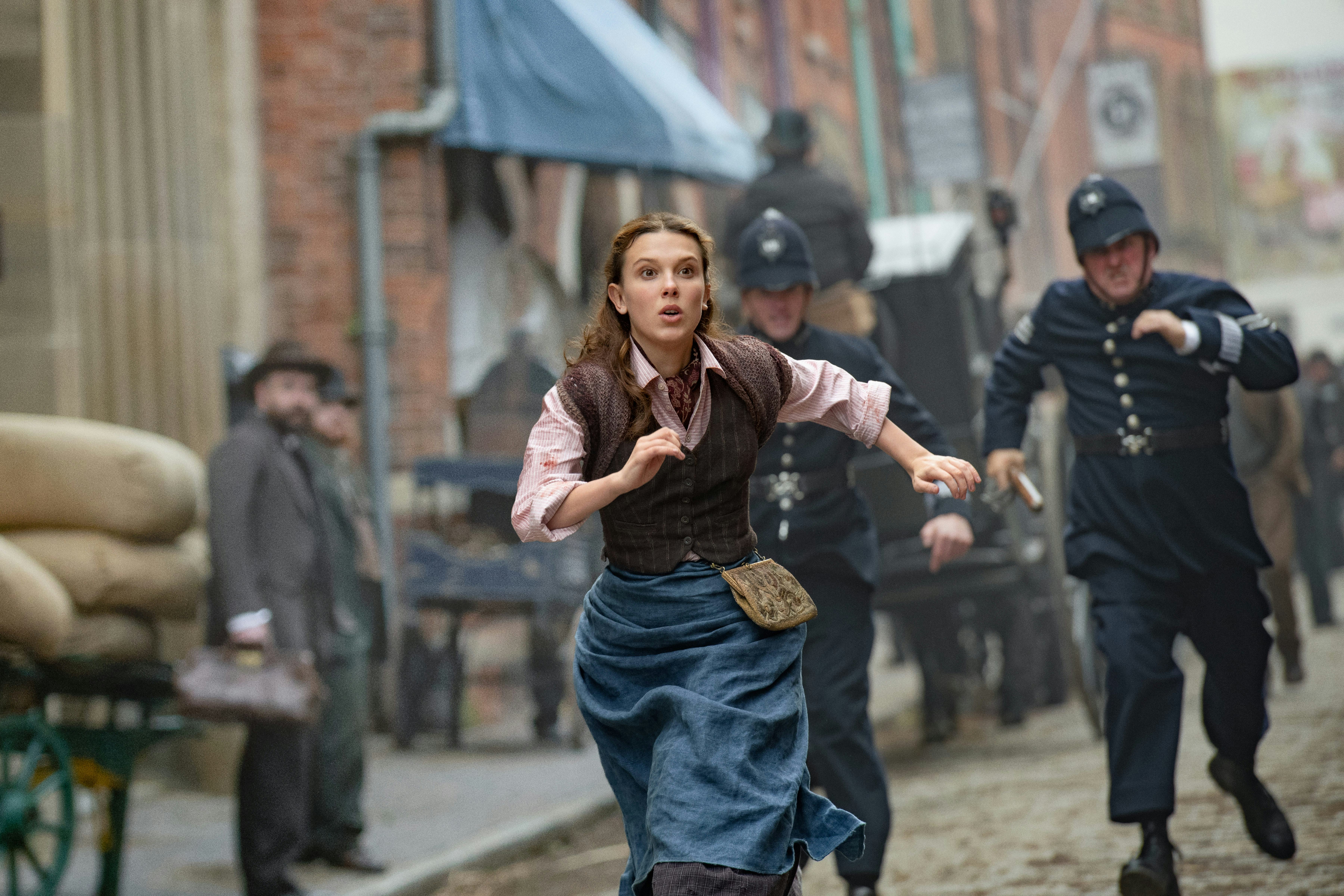 Millie Bobby Brown runs from the police in 'Enola Holmes 2'