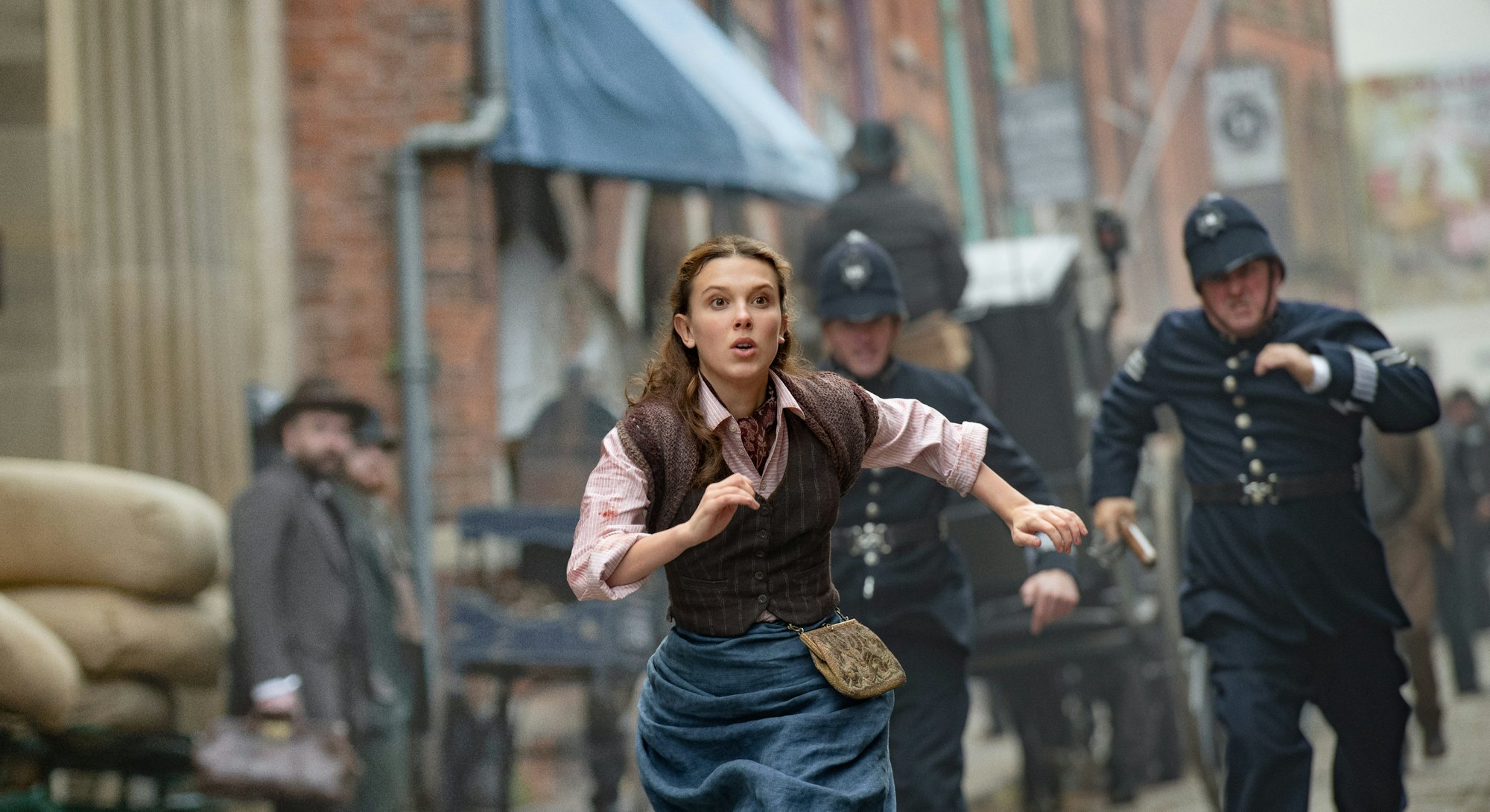 Millie Bobby Brown runs from the police in 'Enola Holmes 2'