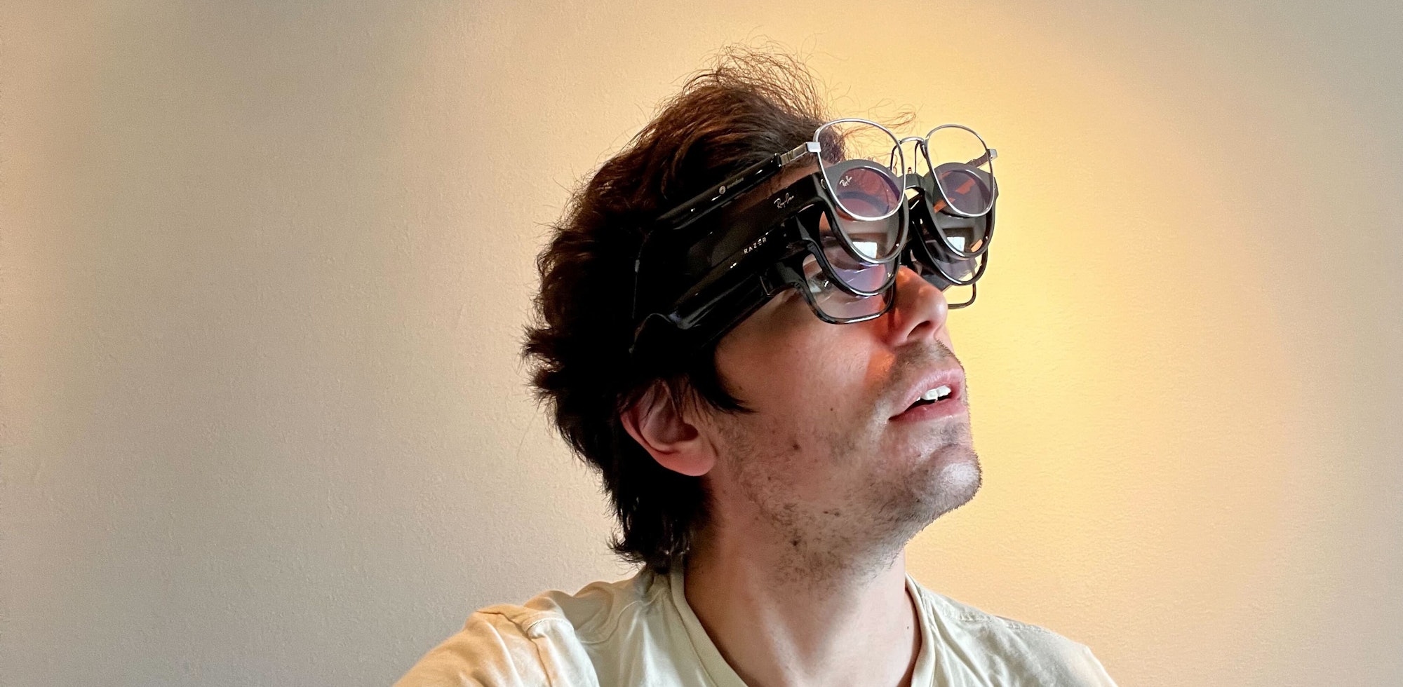 Ian wearing multiple pairs of smart glasses at once.