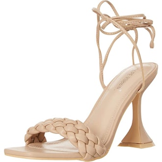 a pair of braided nude sandals with a flared heel