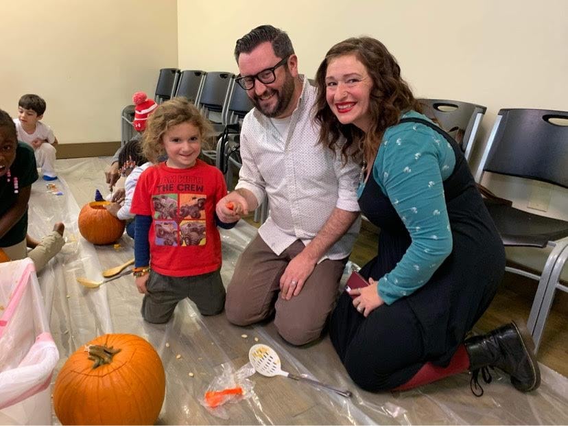 The author and her son and husband carving pumpkins without alcohol present.