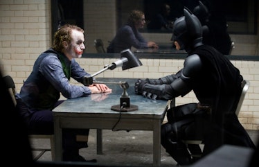 Joker and Batman sitting together at a table