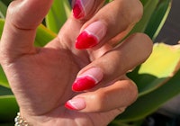 abstract red french tip nails with trippy pattern