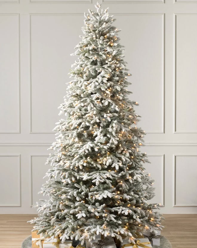 This Frosted Fraser Fir 7.5' Artificial Christmas Tree With Candlelight Clear LED Lights is one of t...