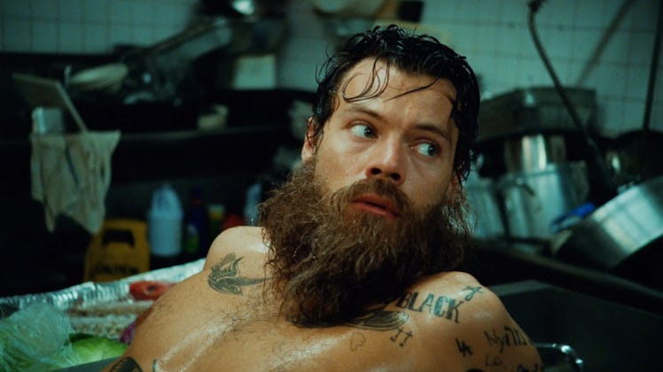 Harry Styles with a beard in the "Music for a Sushi Restaurant" music video.