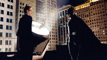 Batman standing on top of a building