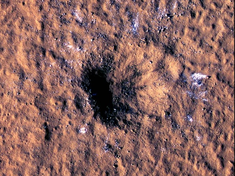 The brown-colored surface of Mars with a deep crater that was caused by a Meteor strike