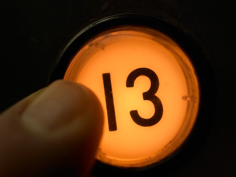 Finger pushing floor 13 elevator button