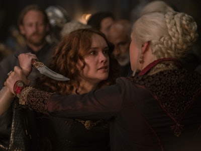 Alicent Hightower (Olivia Cooke) pushes a dagger toward Rhaenyra Targaryen (Emma D'Arcy) in House of...