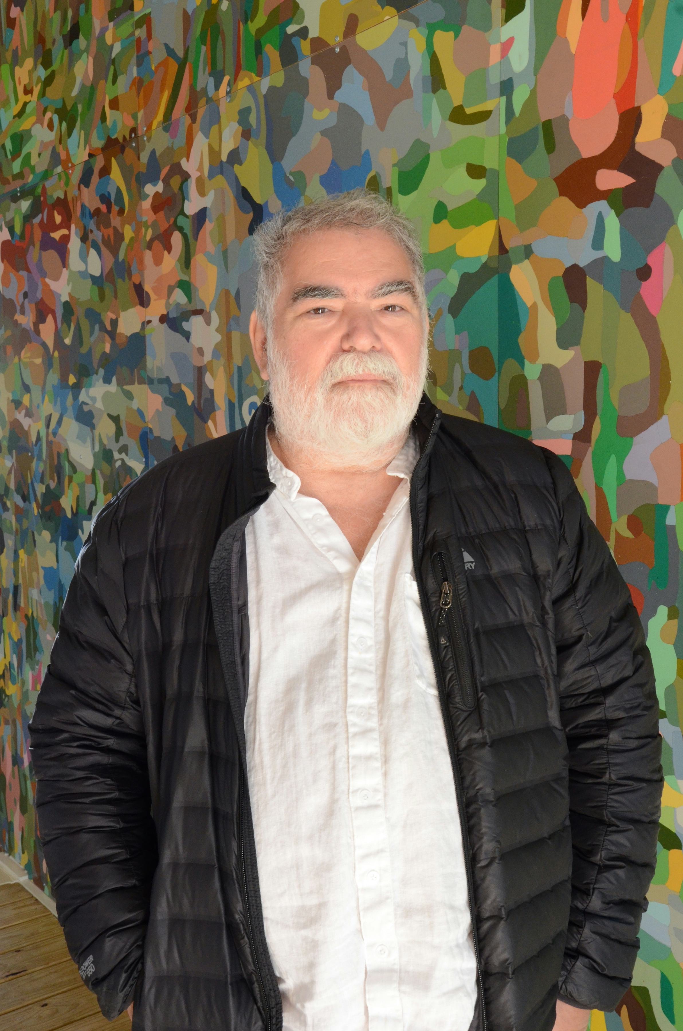 A photo of Jorge Pardo in front of his exhibition