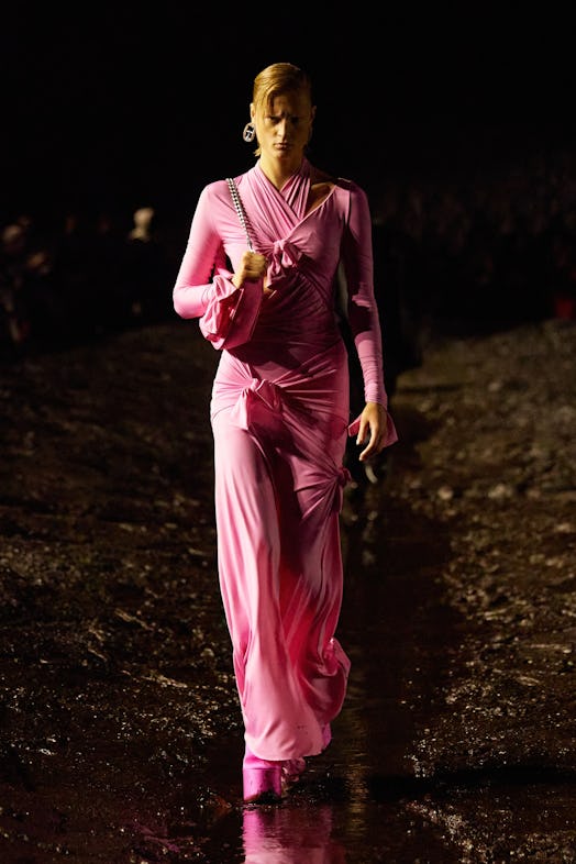 A female model walking the mud Balenciaga show in a pink dress