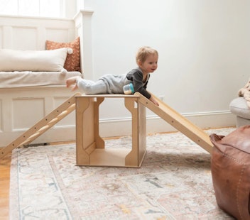 Boy on wooden Montessori play furniture