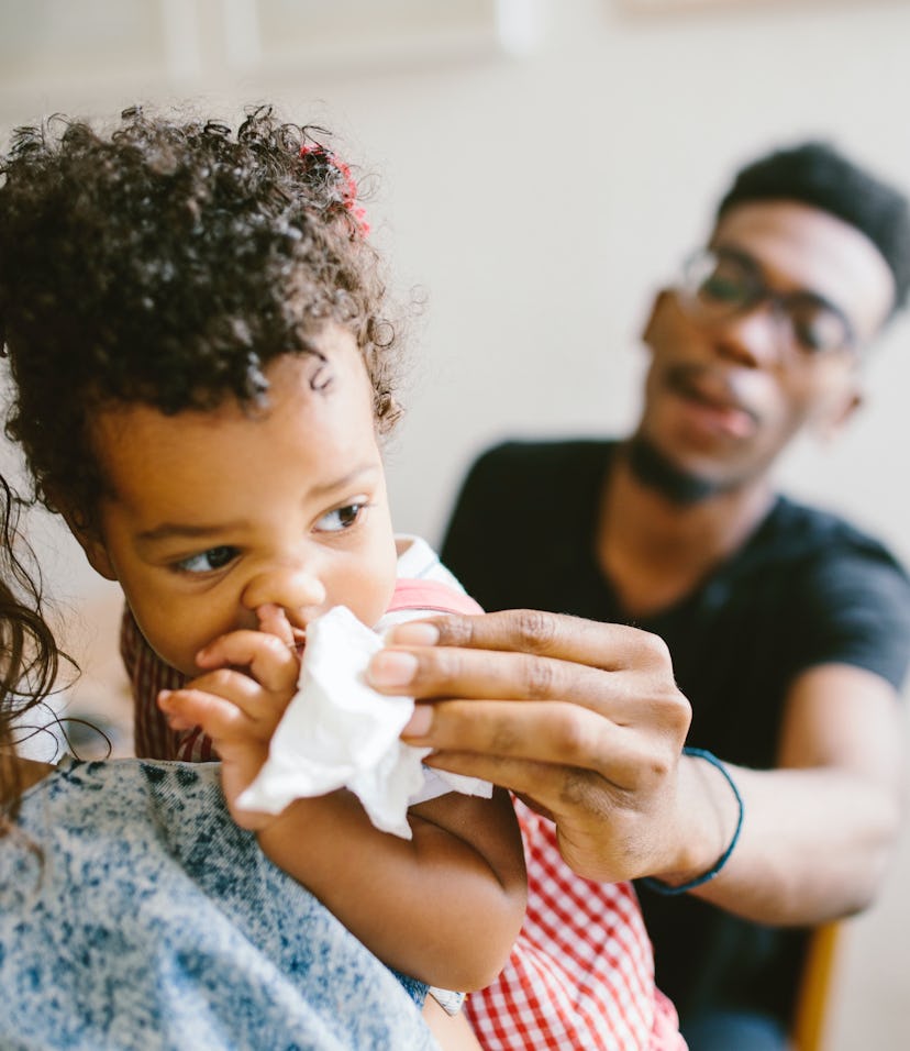 a child with a sniffly nose, a symptom of respiratory virus RSV, common in babies.