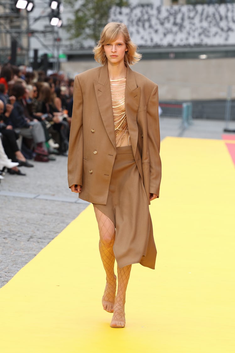 A model in Stella McCartney oversized nude blazer and asymmetrical skirt at Paris Fashion Week Sprin...