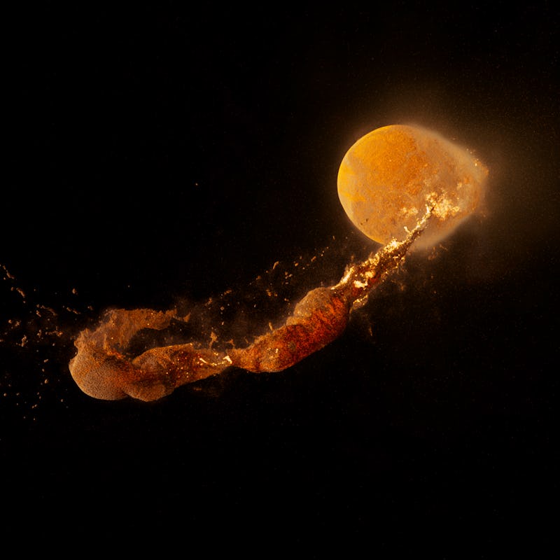 A long streak of matter swirls from the Earth after a powerful collision