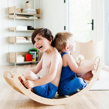 Boys playing on wooden arch