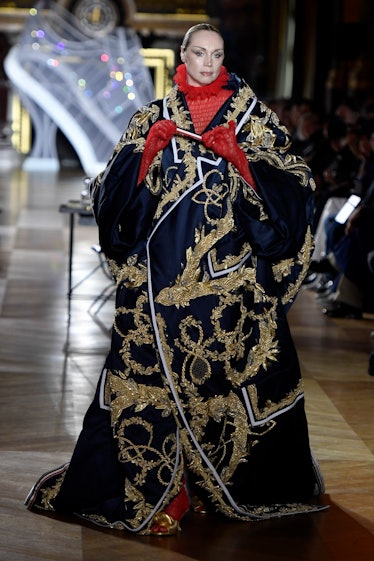 Gwendoline Christie walking the spring 2023 Thom Browne show in a voluminous embroidered robe