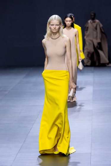 A model in Valentino nude and yellow maxi dress