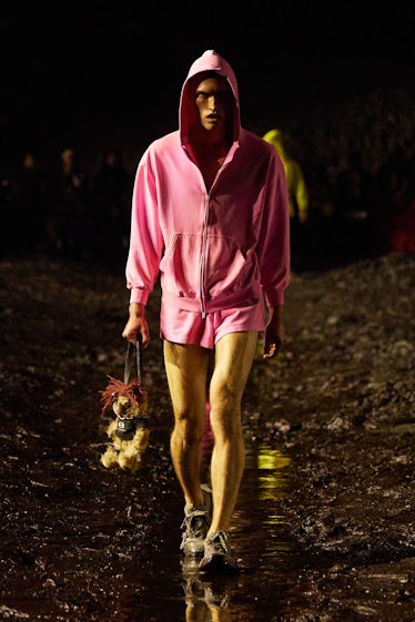 A male model walking the mud Balenciaga show in a pink hoodie 