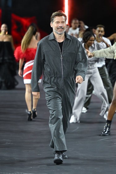 Nikolaj Coster-Waldau wearing a grey boiler suit on the spring 2023 L'Oréal runway