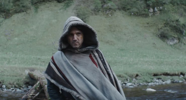 Diego Luna wearing a coat near the forest as Cassian Andor