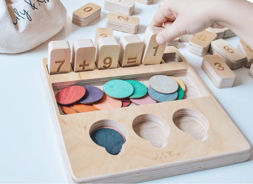 child playing with early math tabletop game