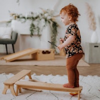 Child on wooden balancing beams