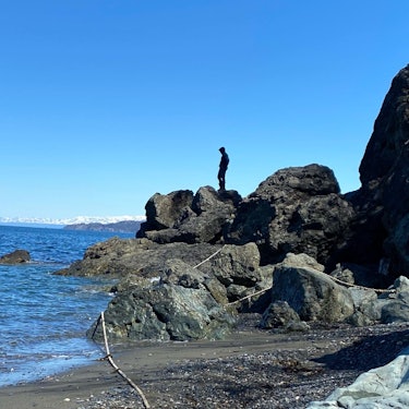 the writer's son on the rocks harvesting salmon in Alaska 