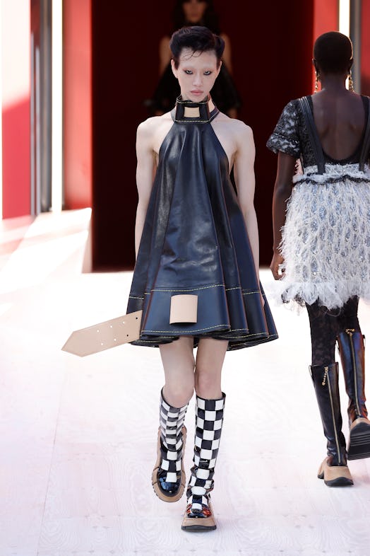 A model in a black leather dress at the Louis Vuitton Spring 2023 Paris Fashion Week