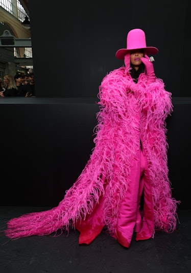 Erykah Badu wearing a pink feathered Valentino coat and hat