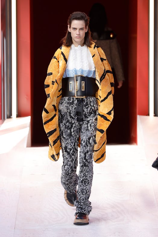 A model in a white top, leopard-print coat, grey trousers at the Louis Vuitton Spring 2023 Paris Fas...
