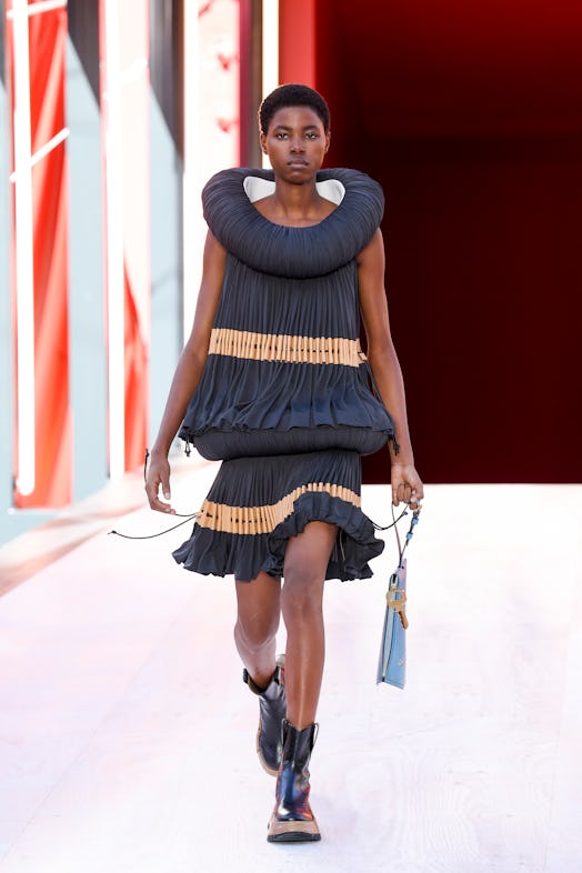 A model in a black-beige pleated dress at the Louis Vuitton Spring 2023 Paris Fashion Week