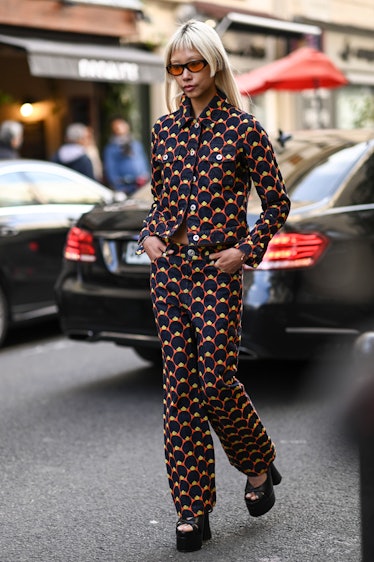 Vanessa Hong is seen wearing a black and orange geometric print top and pants outside the Lanvin sho...
