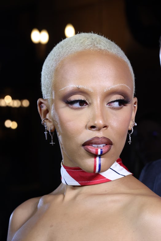 Doja Cat with Thom Browne's signature stripes painted on her lips